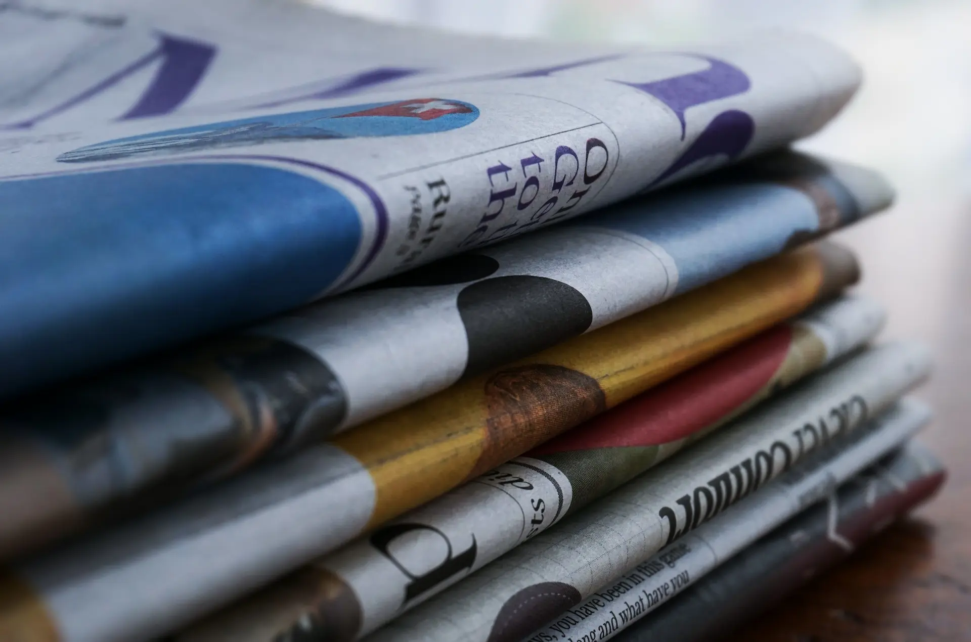 A stack of folded newspapers